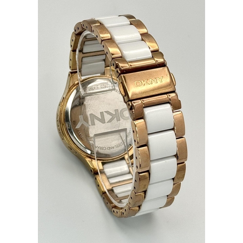 231 - A rose gold plated, Ceramic DKNY Chronometer watch, 38 mm case, bezel with cubic zirconia, white dia... 