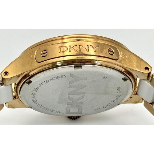 231 - A rose gold plated, Ceramic DKNY Chronometer watch, 38 mm case, bezel with cubic zirconia, white dia... 