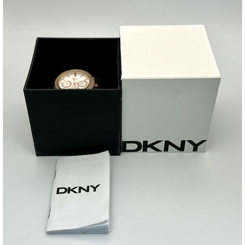 231 - A rose gold plated, Ceramic DKNY Chronometer watch, 38 mm case, bezel with cubic zirconia, white dia... 