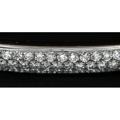 32 - AN 18K WHITE GOLD DIAMOND SET BANGLE. 1.20CTW. 9G. CLIP DESIGN. 6CM INNER DIAMETER. SC3024.