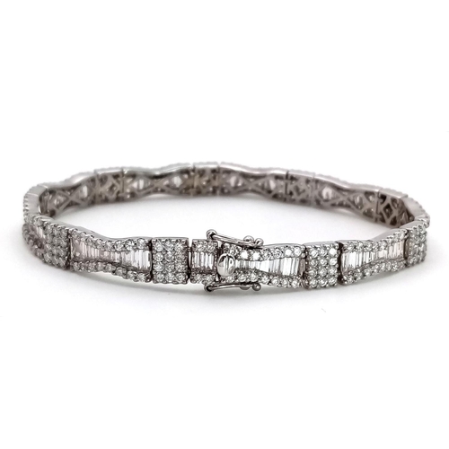 5 - AN 18K WHITE GOLD AND DIAMOND FANCY TENNIS BRACELET. BOW TIE BAGUETTE DIAMOND SHAPES WITH ROUND CUT ... 