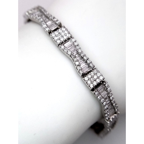 5 - AN 18K WHITE GOLD AND DIAMOND FANCY TENNIS BRACELET. BOW TIE BAGUETTE DIAMOND SHAPES WITH ROUND CUT ... 