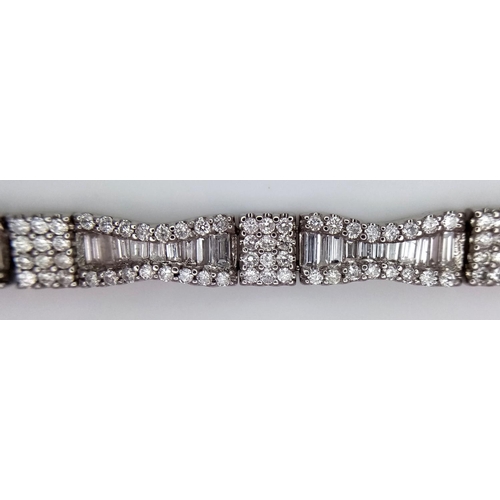 5 - AN 18K WHITE GOLD AND DIAMOND FANCY TENNIS BRACELET. BOW TIE BAGUETTE DIAMOND SHAPES WITH ROUND CUT ... 