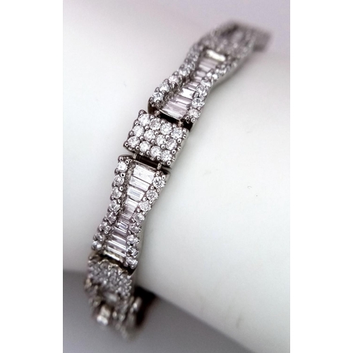 5 - AN 18K WHITE GOLD AND DIAMOND FANCY TENNIS BRACELET. BOW TIE BAGUETTE DIAMOND SHAPES WITH ROUND CUT ... 