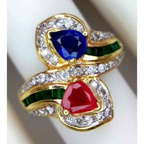 54 - AN 18K YELLOW GOLD DIAMOND, SAPPHIRE, RUBY & EMERALD TWIST RING. 6.6G. SIZE J. A/S SC17.