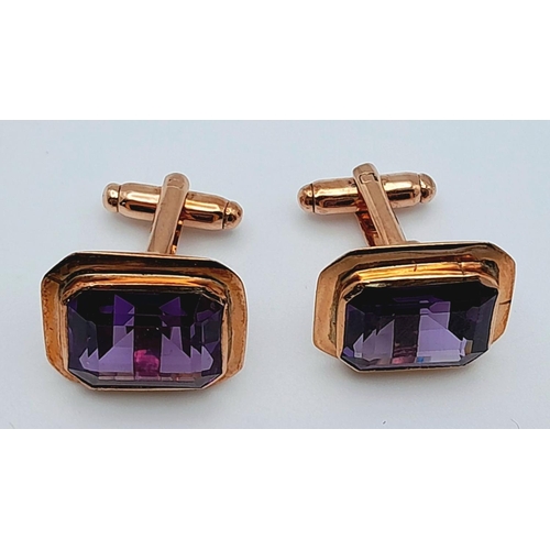 596 - A Pair of 9K Yellow Gold Amethyst Cufflinks. Rectangular step cut. 11.3g total weight.