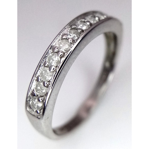 607 - A 9K WHITE GOLD DIAMOND HALF ETERNITY RING. 0.25CTW. 1.8G. SIZE J. SC3007.