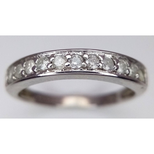 607 - A 9K WHITE GOLD DIAMOND HALF ETERNITY RING. 0.25CTW. 1.8G. SIZE J. SC3007.