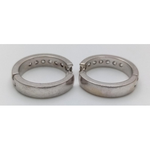 61 - A PAIR OF 14K WHITE GOLD DIAMONDS HALF ETERNITY HOOP EARRINGS. 0.60CTW. 7.5G. A/S 1156