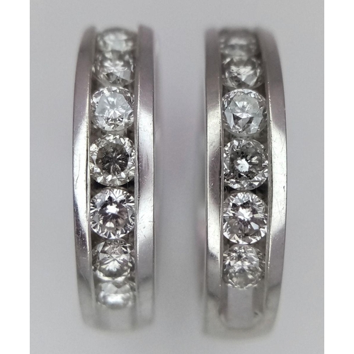 61 - A PAIR OF 14K WHITE GOLD DIAMONDS HALF ETERNITY HOOP EARRINGS. 0.60CTW. 7.5G. A/S 1156