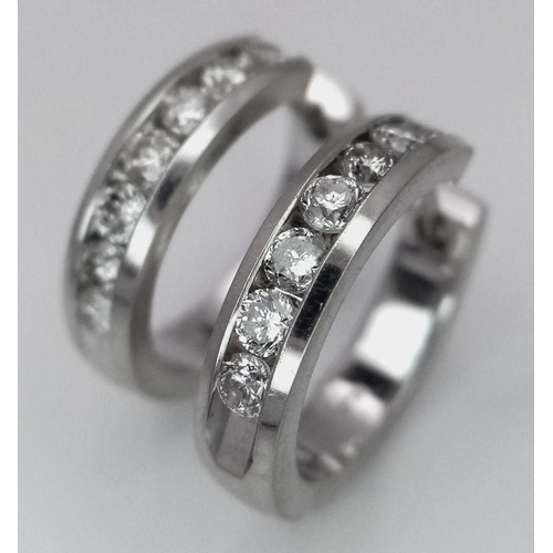 61 - A PAIR OF 14K WHITE GOLD DIAMONDS HALF ETERNITY HOOP EARRINGS. 0.60CTW. 7.5G. A/S 1156