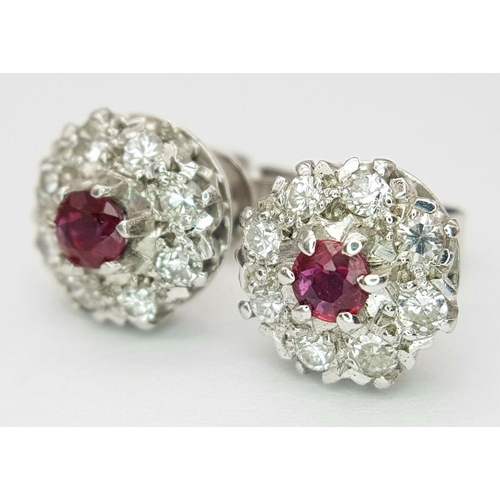 75 - A PAIR OF 18K WHITE GOLD DIAMOND & RUBY CLUSTER STUD EARRINGS. 0.50CTS DIAMONDS. 4.2G. SP3011.