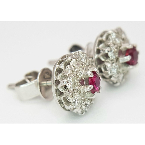 75 - A PAIR OF 18K WHITE GOLD DIAMOND & RUBY CLUSTER STUD EARRINGS. 0.50CTS DIAMONDS. 4.2G. SP3011.