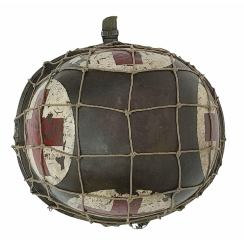 173 - A WW2 US Medics Helmet. With a Capac Liner. Both Helmet and liner bear the red cross insignia. The h... 