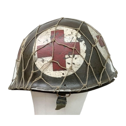 173 - A WW2 US Medics Helmet. With a Capac Liner. Both Helmet and liner bear the red cross insignia. The h... 