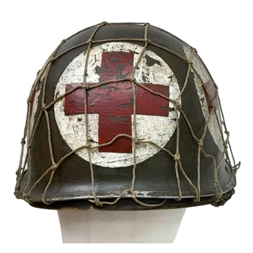 173 - A WW2 US Medics Helmet. With a Capac Liner. Both Helmet and liner bear the red cross insignia. The h... 