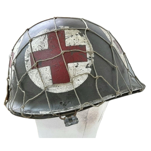 173 - A WW2 US Medics Helmet. With a Capac Liner. Both Helmet and liner bear the red cross insignia. The h... 