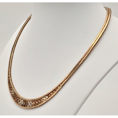 38 - A Glamourous Tri-Colour 9K Gold Necklace. Mesh design in herringbone form. 42cm length. 31g.