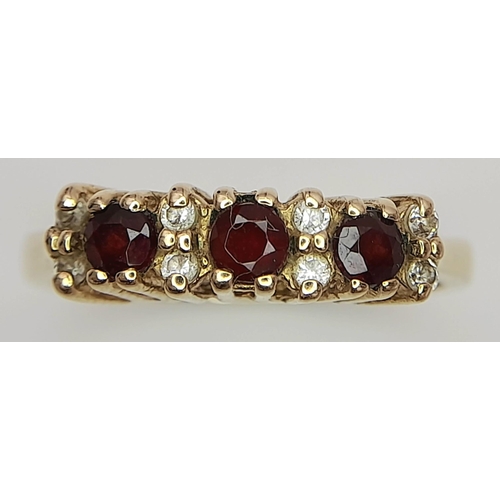 209 - An impressive 9 carat GOLD, TRIPLE GARNET and ZIRCONIA RING. Having gemstones set to top in a beauti... 