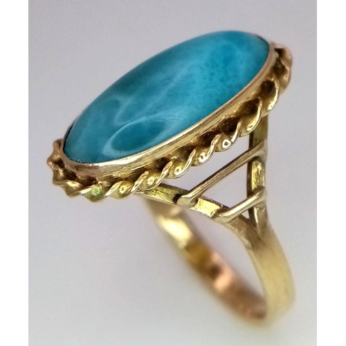 211 - A Beautiful Vintage 14K Yellow Gold Larimar Gemstone Ring.
A larimar cabochon in a decorative scroll... 