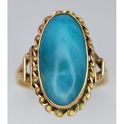 211 - A Beautiful Vintage 14K Yellow Gold Larimar Gemstone Ring.
A larimar cabochon in a decorative scroll... 