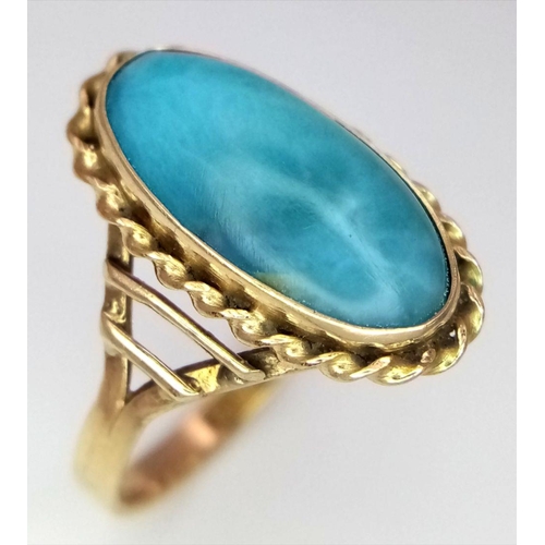 211 - A Beautiful Vintage 14K Yellow Gold Larimar Gemstone Ring.
A larimar cabochon in a decorative scroll... 