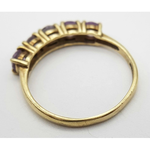 216 - Extremely pretty hallmarked 9 carat GOLD RING, with a Sweep of 5 Pale Amethyst coloured Gemstones se... 