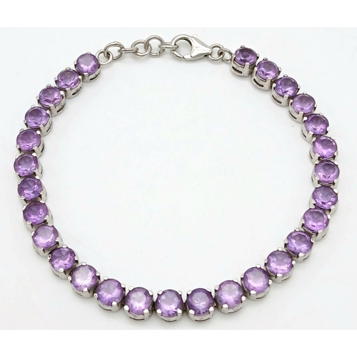 605 - A Sterling Silver Round Cut Amethyst Tennis Bracelet. 19.5cm Length. Set with 5.5mm Round Cut Amethy... 