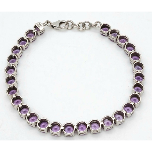 605 - A Sterling Silver Round Cut Amethyst Tennis Bracelet. 19.5cm Length. Set with 5.5mm Round Cut Amethy... 