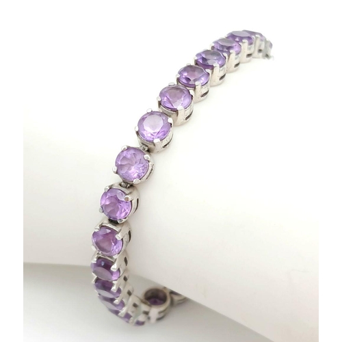 605 - A Sterling Silver Round Cut Amethyst Tennis Bracelet. 19.5cm Length. Set with 5.5mm Round Cut Amethy... 