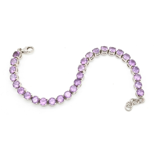 605 - A Sterling Silver Round Cut Amethyst Tennis Bracelet. 19.5cm Length. Set with 5.5mm Round Cut Amethy... 