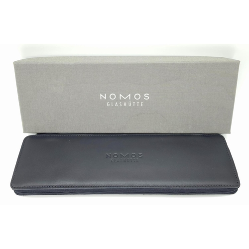 157 - A Nomos Tangomat Automatic Gents Watch. Black leather strap. Stainless steel case - 38mm. Black dial... 