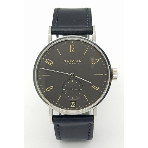 157 - A Nomos Tangomat Automatic Gents Watch. Black leather strap. Stainless steel case - 38mm. Black dial... 