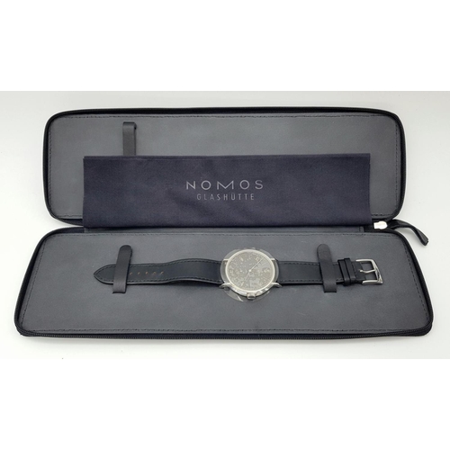 157 - A Nomos Tangomat Automatic Gents Watch. Black leather strap. Stainless steel case - 38mm. Black dial... 