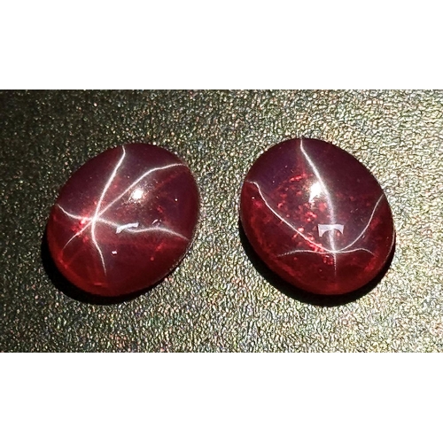 217 - A wonderful pair of SIX RAY STAR RUBY cabochons, 12 x 10 x 5 mm, with strong reaction to UV light an... 