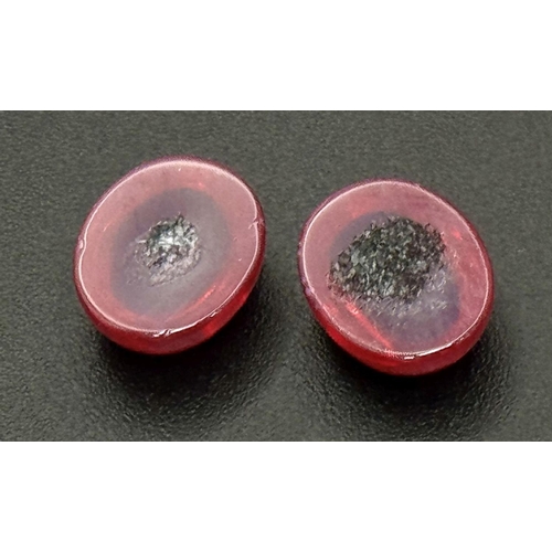 217 - A wonderful pair of SIX RAY STAR RUBY cabochons, 12 x 10 x 5 mm, with strong reaction to UV light an... 