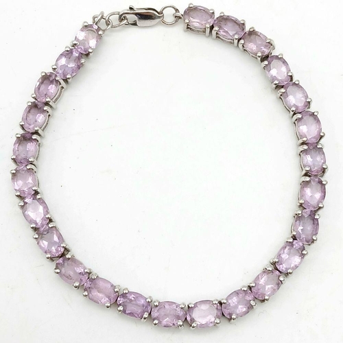 598 - A Sterling Silver Round Cut Amethyst Tennis Bracelet. 20cm Length. Set with 5mm Round Cut Amethysts.... 