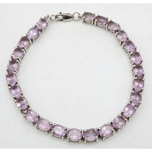 598 - A Sterling Silver Round Cut Amethyst Tennis Bracelet. 20cm Length. Set with 5mm Round Cut Amethysts.... 