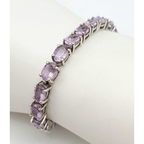 598 - A Sterling Silver Round Cut Amethyst Tennis Bracelet. 20cm Length. Set with 5mm Round Cut Amethysts.... 