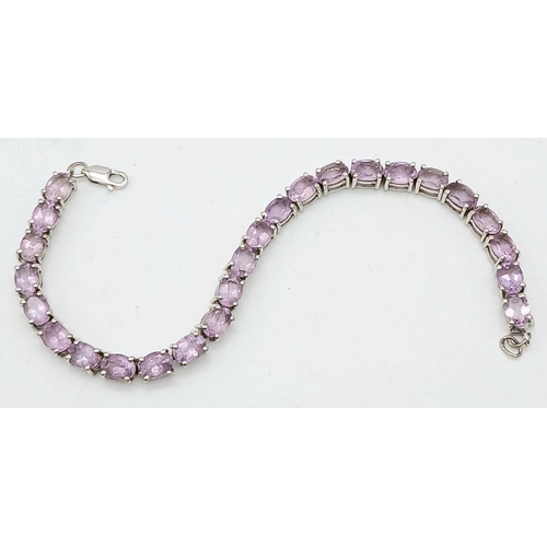 598 - A Sterling Silver Round Cut Amethyst Tennis Bracelet. 20cm Length. Set with 5mm Round Cut Amethysts.... 