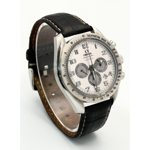 185 - An Omega Speedmaster Broad Arrow Automatic Chronograph Gents Watch. Black leather strap. Stainless s... 