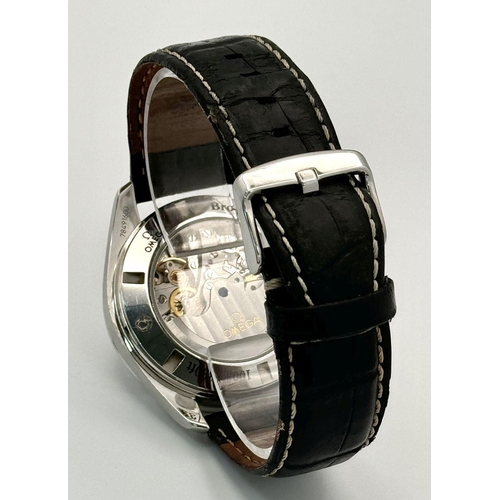 185 - An Omega Speedmaster Broad Arrow Automatic Chronograph Gents Watch. Black leather strap. Stainless s... 