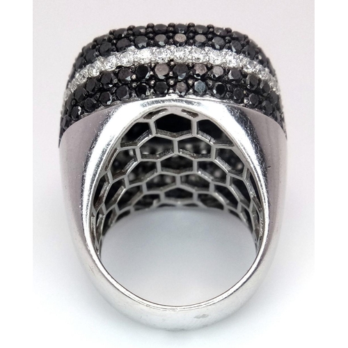 94 - An 18K White Gold, Diamond and Onyx Dress Ring. Make a statement with this rich square of black onyx... 