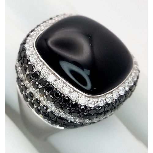 94 - An 18K White Gold, Diamond and Onyx Dress Ring. Make a statement with this rich square of black onyx... 