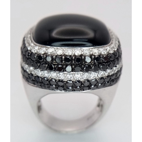 94 - An 18K White Gold, Diamond and Onyx Dress Ring. Make a statement with this rich square of black onyx... 