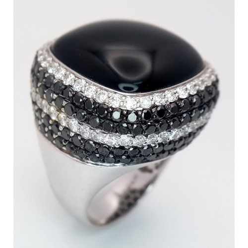 94 - An 18K White Gold, Diamond and Onyx Dress Ring. Make a statement with this rich square of black onyx... 