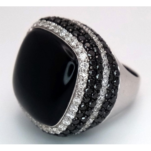 94 - An 18K White Gold, Diamond and Onyx Dress Ring. Make a statement with this rich square of black onyx... 