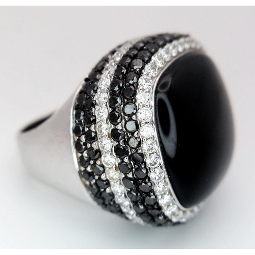 94 - An 18K White Gold, Diamond and Onyx Dress Ring. Make a statement with this rich square of black onyx... 