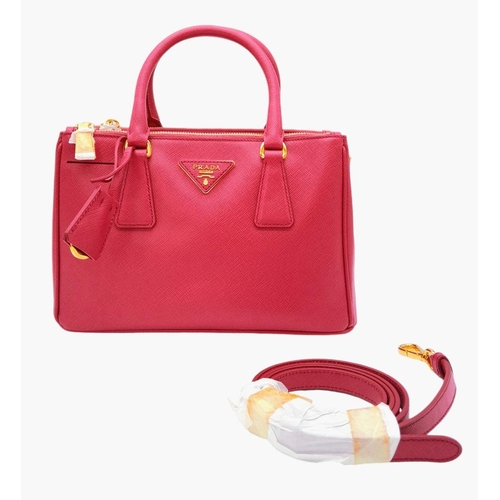 101 - A Prada Saffiano Vernice Galleria Handbag. Pink cross-grain saffiano leather exterior, gold-toned ha... 