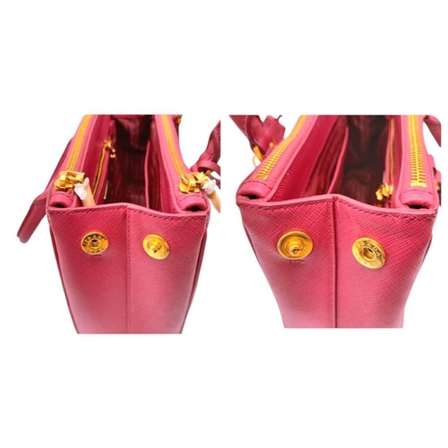 101 - A Prada Saffiano Vernice Galleria Handbag. Pink cross-grain saffiano leather exterior, gold-toned ha... 